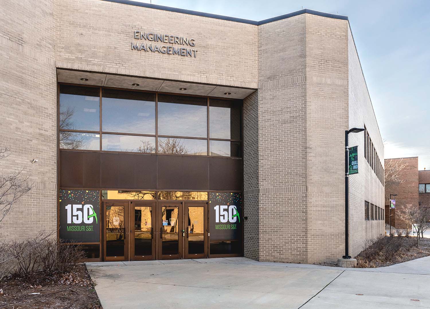 Front of building with glass doors and window decals on the left and right.